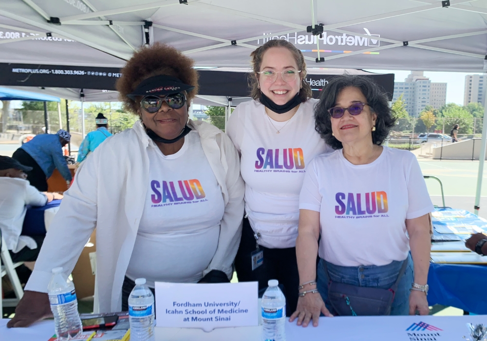 black, white, and latino women at outside event